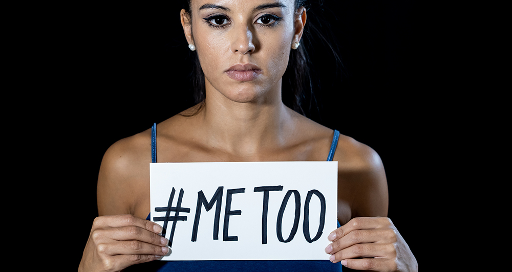 Portrait of young woman holding a note with the text me too