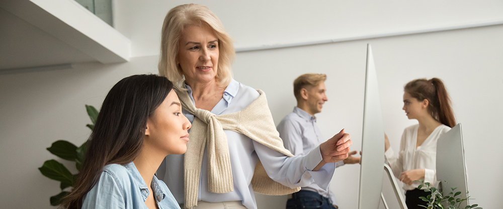 Female mentor helping employee