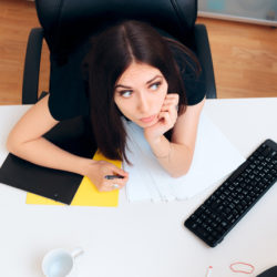 woman at desk spacing out