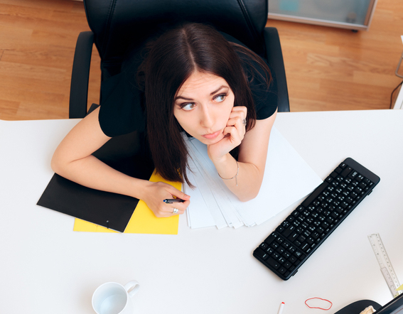 woman at desk spacing out